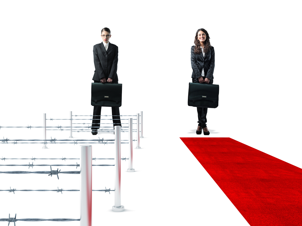 Two women in business suits survey what is in front of them. One stands before hurdles with barbed wire strung between them. The other has a red carpet laid out before her. Wouldn't you like to know which you might be?